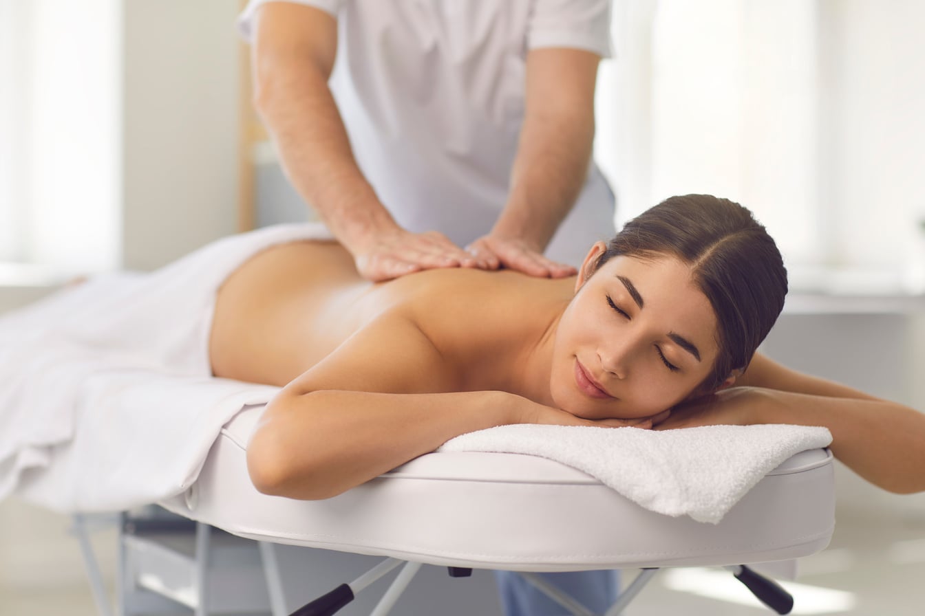 Young Male Osteopath Doing Professional Back Massage for Woman in Medical Center.